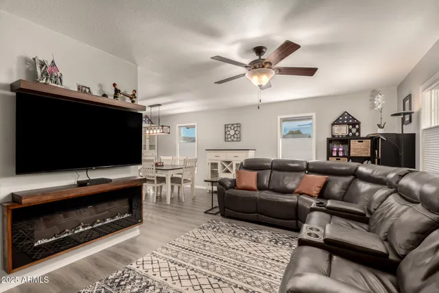 a living room with furniture and a ceiling fan
