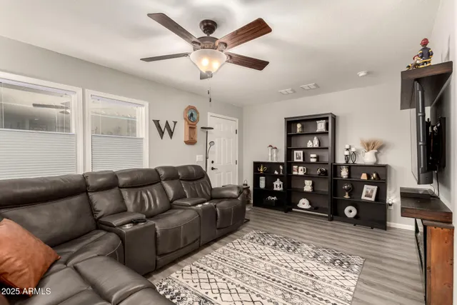 a living room with lots of furniture and wooden floor