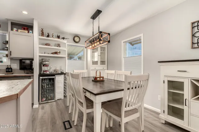 a kitchen with stainless steel appliances granite countertop a stove and white cabinets with wooden floor