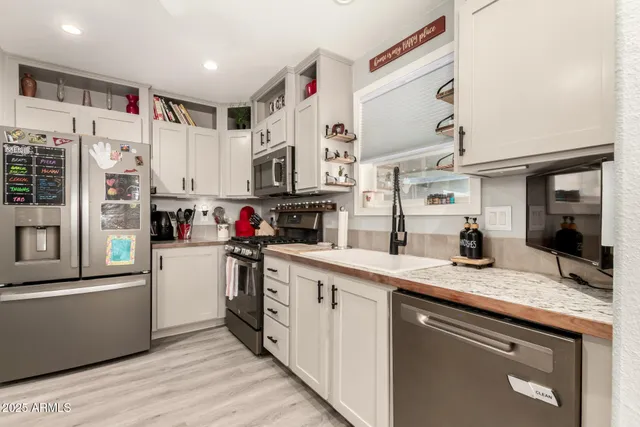 a kitchen with a sink appliances and cabinets