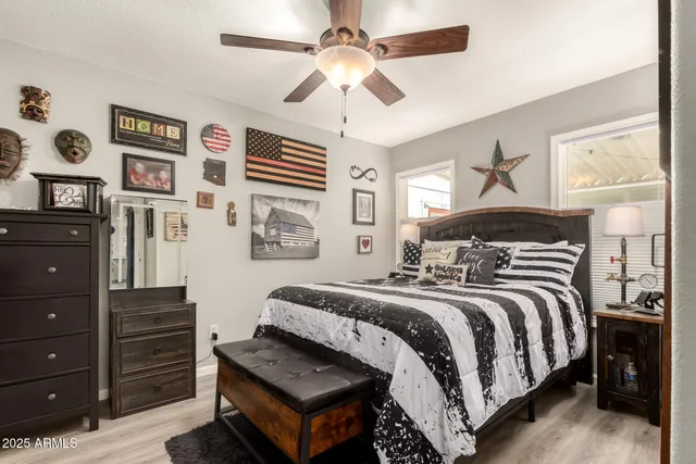 a bedroom with a bed and wooden floor