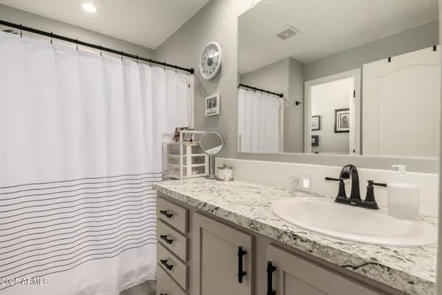 a view of walk in closet with clothes