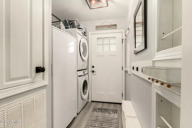 a living room with furniture a rug and white walls