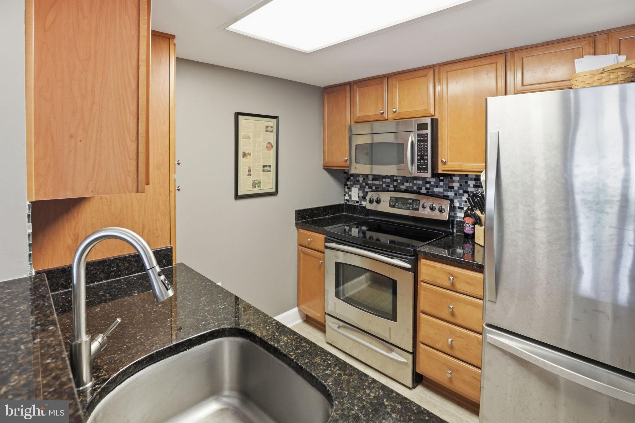 11800 Sunset Hills Road, Unit 218 Reston, VA 20190 - Photo 12 of 38 a kitchen with sink a stove and refrigerator