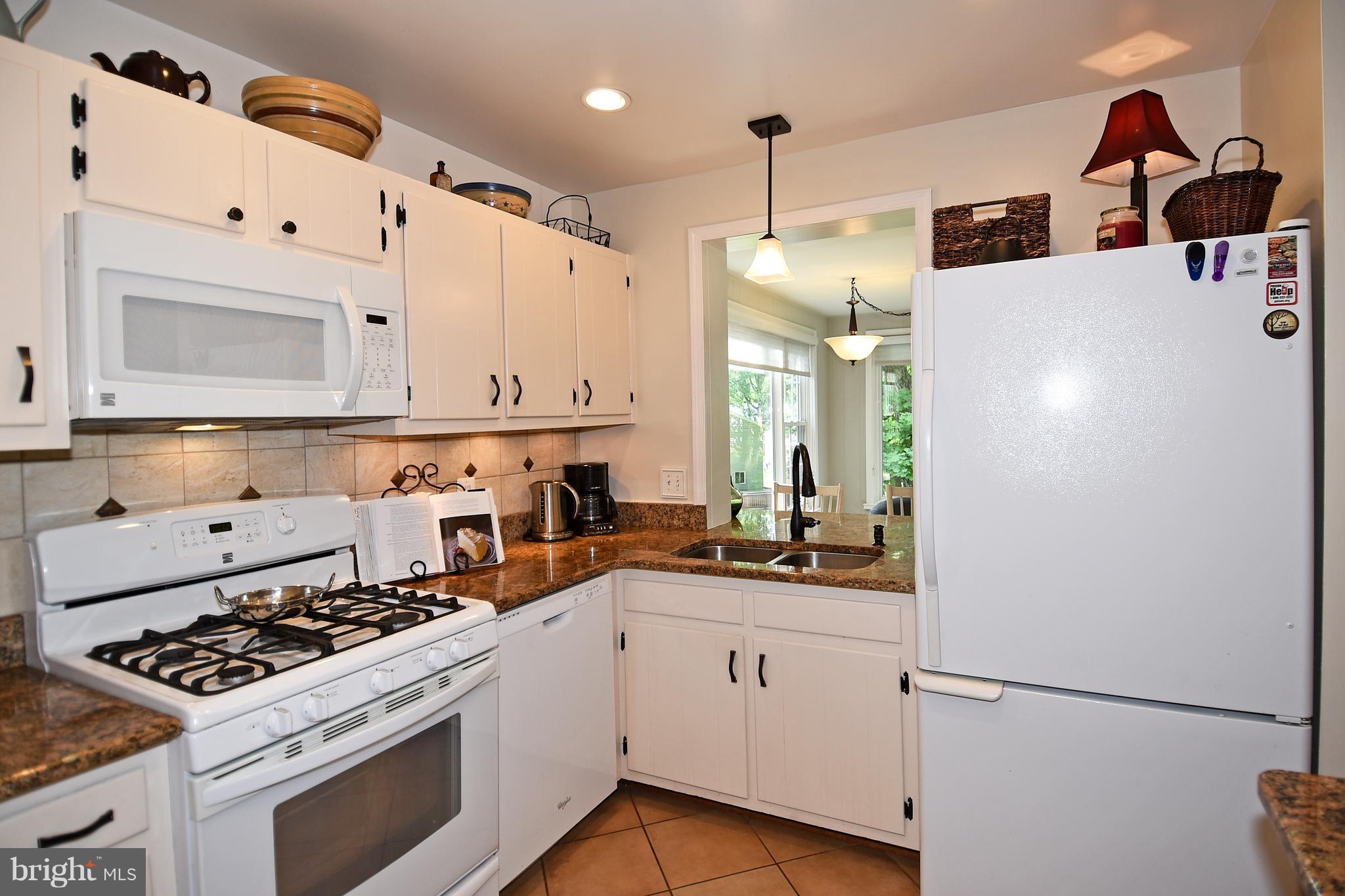 5506 Avon Court Springfield, VA 22151 - Photo 14 of 30 a kitchen with a stove a sink and a refrigerator