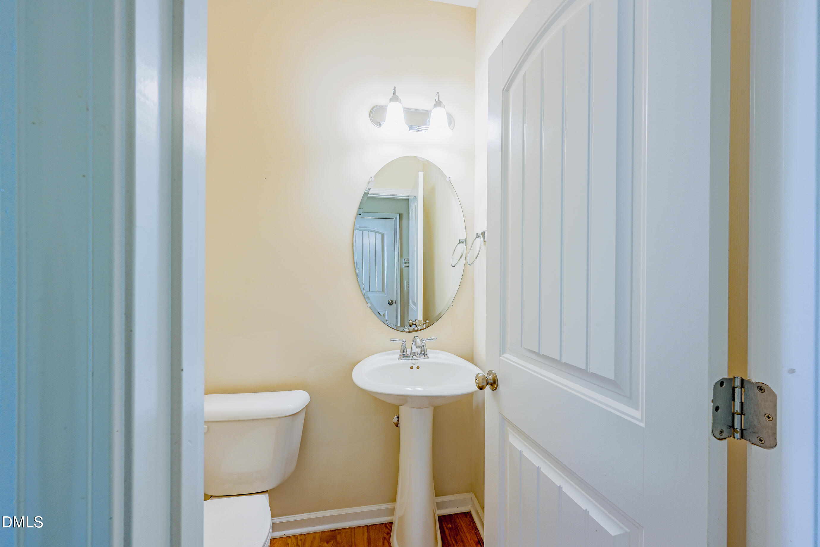 1260 Silver Beach Way Raleigh, NC 27606 - Photo 11 of 24 a bathroom with a toilet a sink and mirror