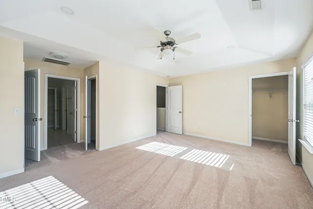 a view of a room with a stylish ceiling fan and entryway