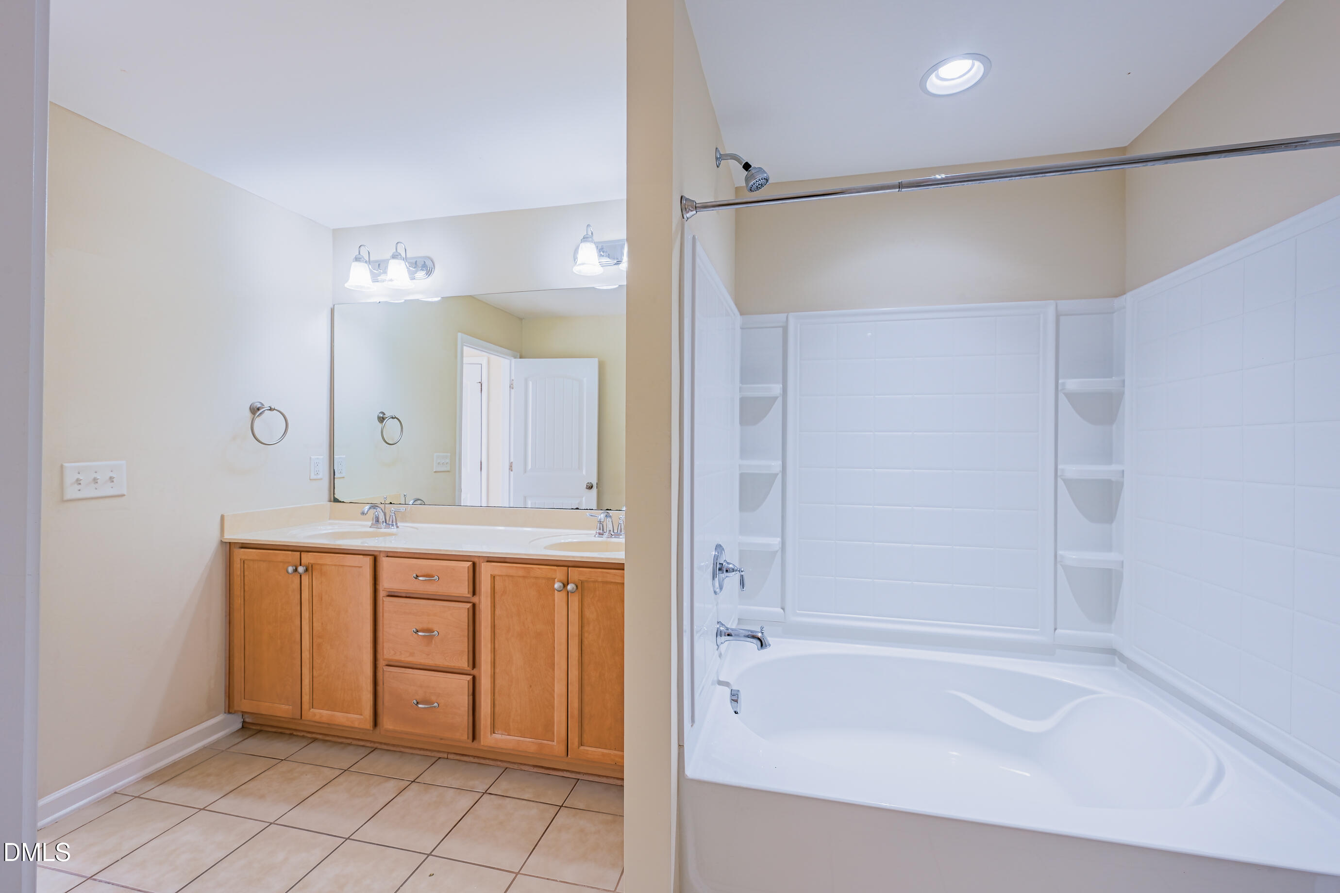 1260 Silver Beach Way Raleigh, NC 27606 - Photo 16 of 24 a bathroom with a bathtub a shower a sink and a mirror