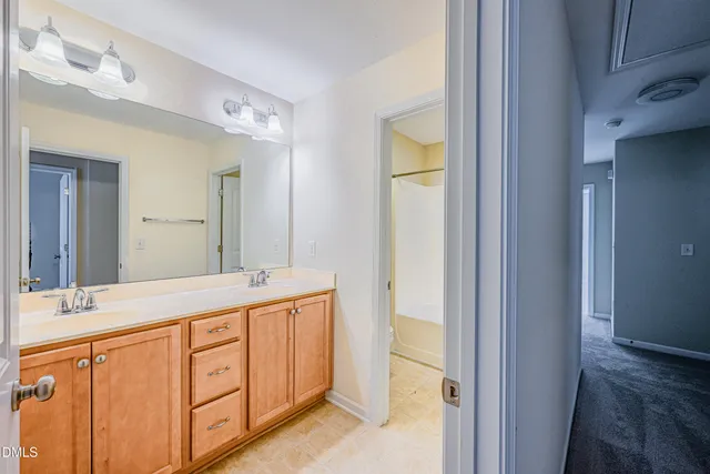 a bathroom with a double vanity sink and a mirror