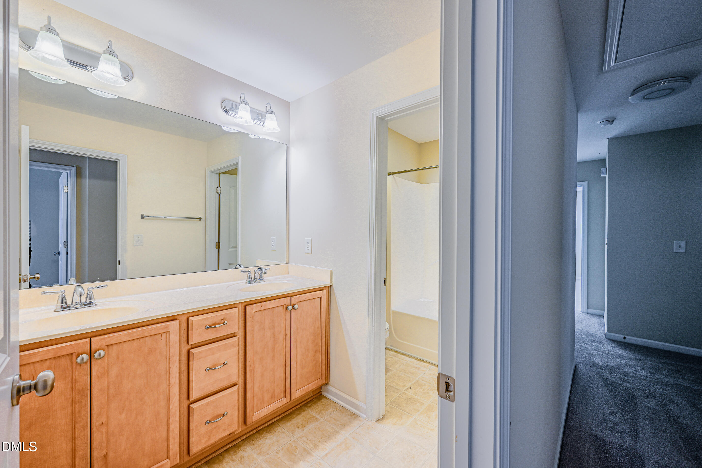 1260 Silver Beach Way Raleigh, NC 27606 - Photo 22 of 24 a bathroom with a double vanity sink and a mirror