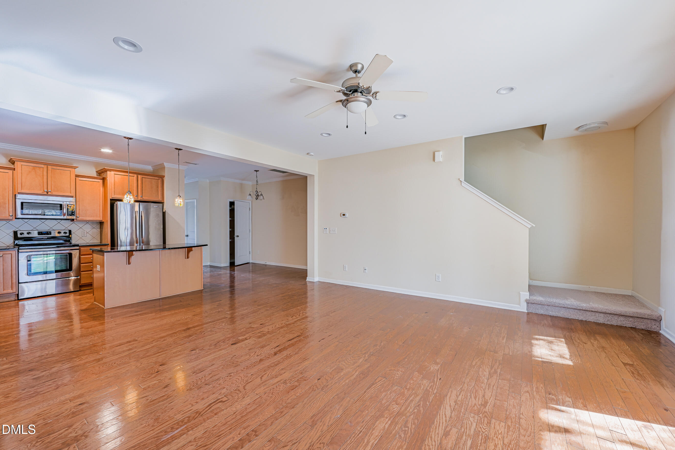 1260 Silver Beach Way Raleigh, NC 27606 - Photo 10 of 24 a view of an empty room and kitchen with wooden floor