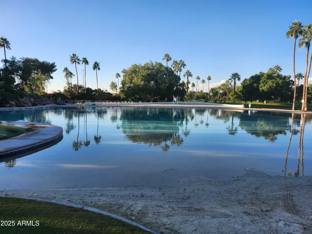 a view of a lake with a table and chairs
