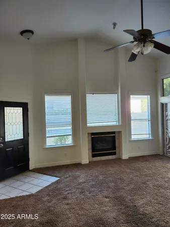 a view of empty room with a fireplace and windows