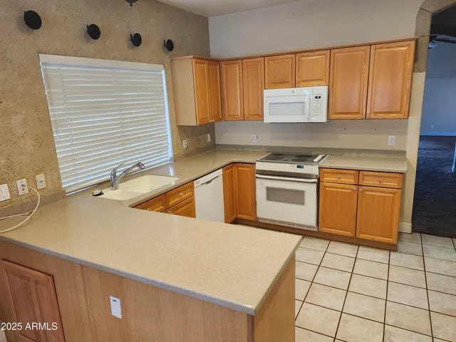 a kitchen that has a sink and a stove