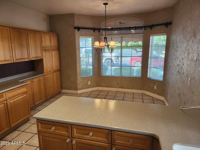 a kitchen with a large window appliances and cabinets