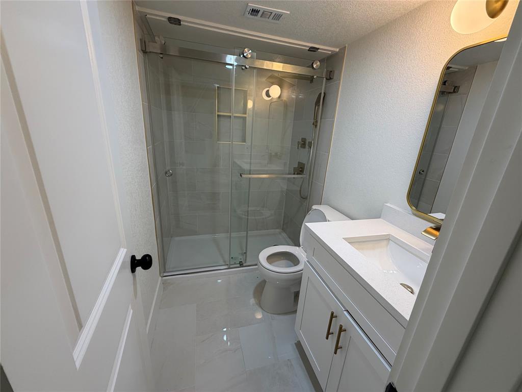 424 Valley Park Drive Garland, TX 75043 - Photo 18 of 18 a bathroom with a sink a toilet and shower