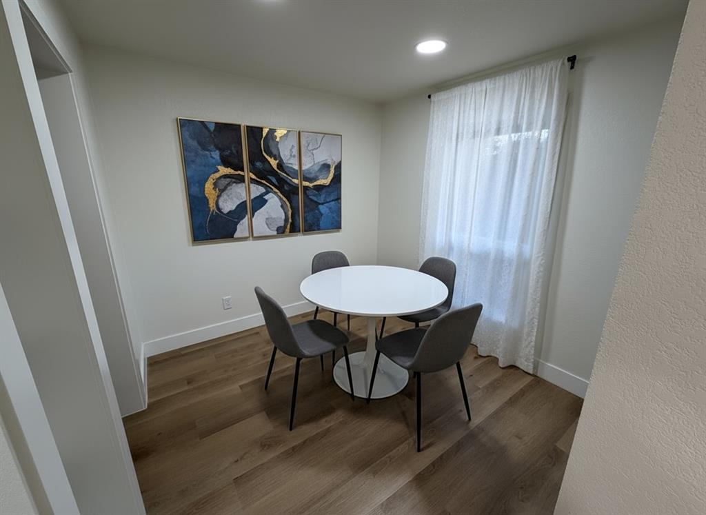 424 Valley Park Drive Garland, TX 75043 - Photo 4 of 18 a view of a dining room with furniture and wooden floor