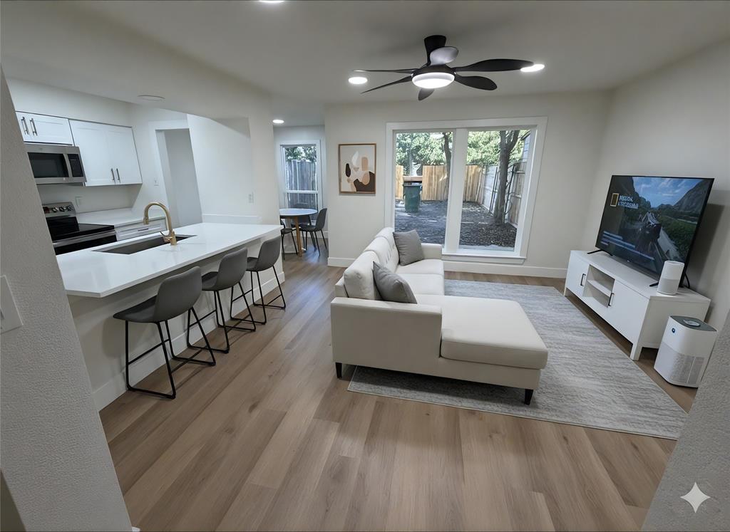 424 Valley Park Drive Garland, TX 75043 - Photo 5 of 18 a living room with furniture and a flat screen tv