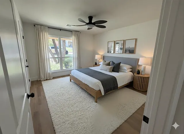 a bedroom with a bed and a large mirror