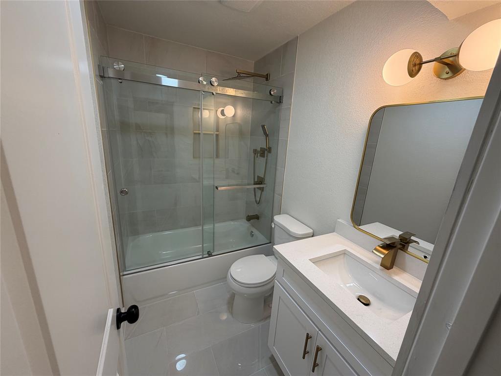 424 Valley Park Drive Garland, TX 75043 - Photo 9 of 18 a bathroom with a sink a toilet and shower