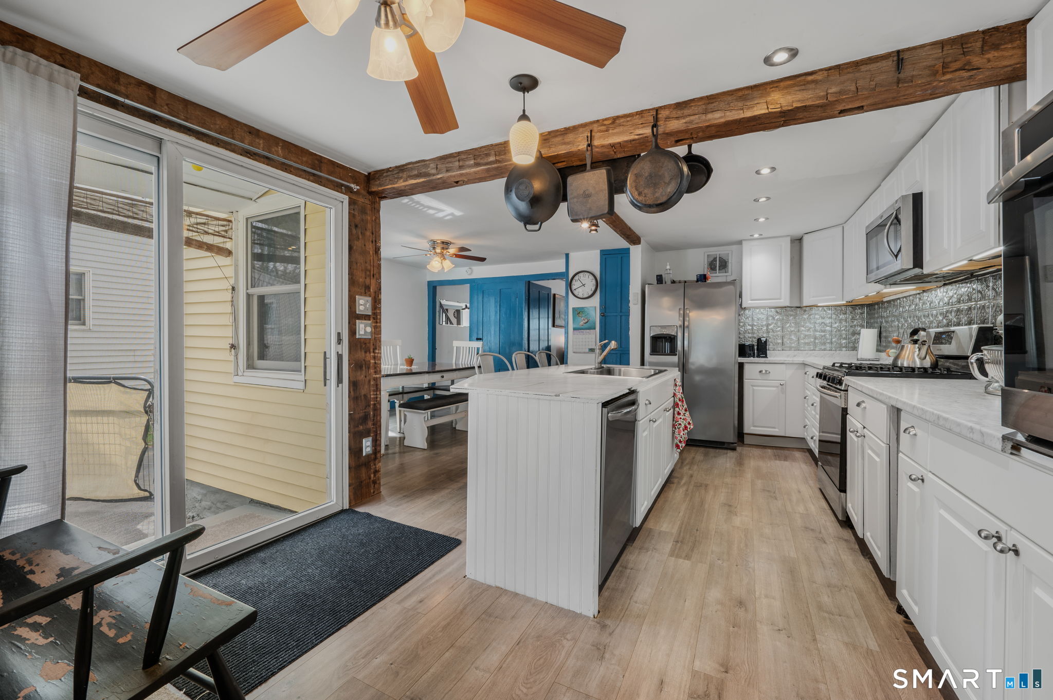 118 Highway 2A Preston, CT 06365 - Photo 13 of 31 a kitchen with stainless steel appliances kitchen island granite countertop a stove top oven a sink a dining table and chairs with wooden floor