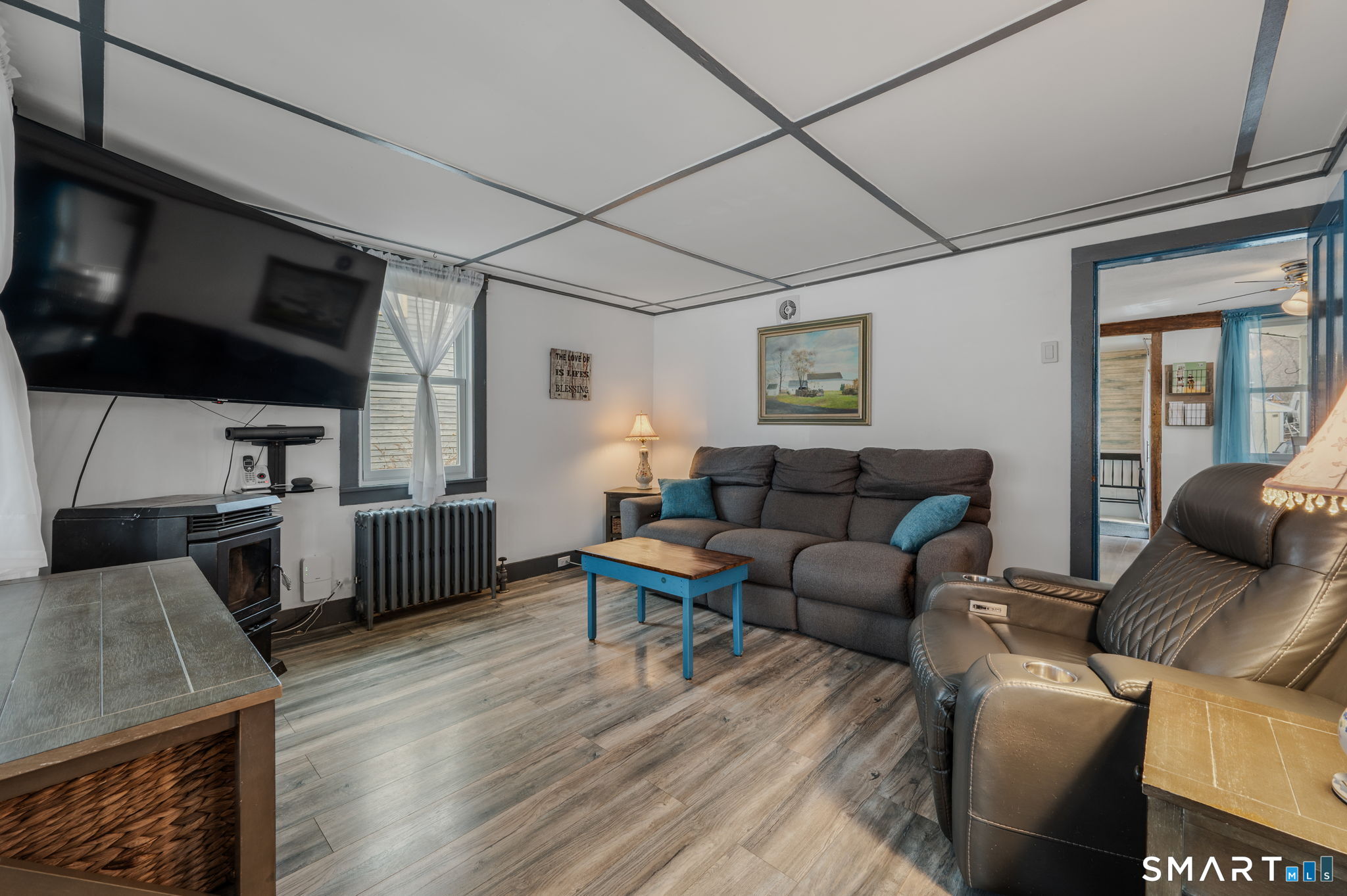 118 Highway 2A Preston, CT 06365 - Photo 5 of 31 a living room with furniture a flat screen tv and kitchen view
