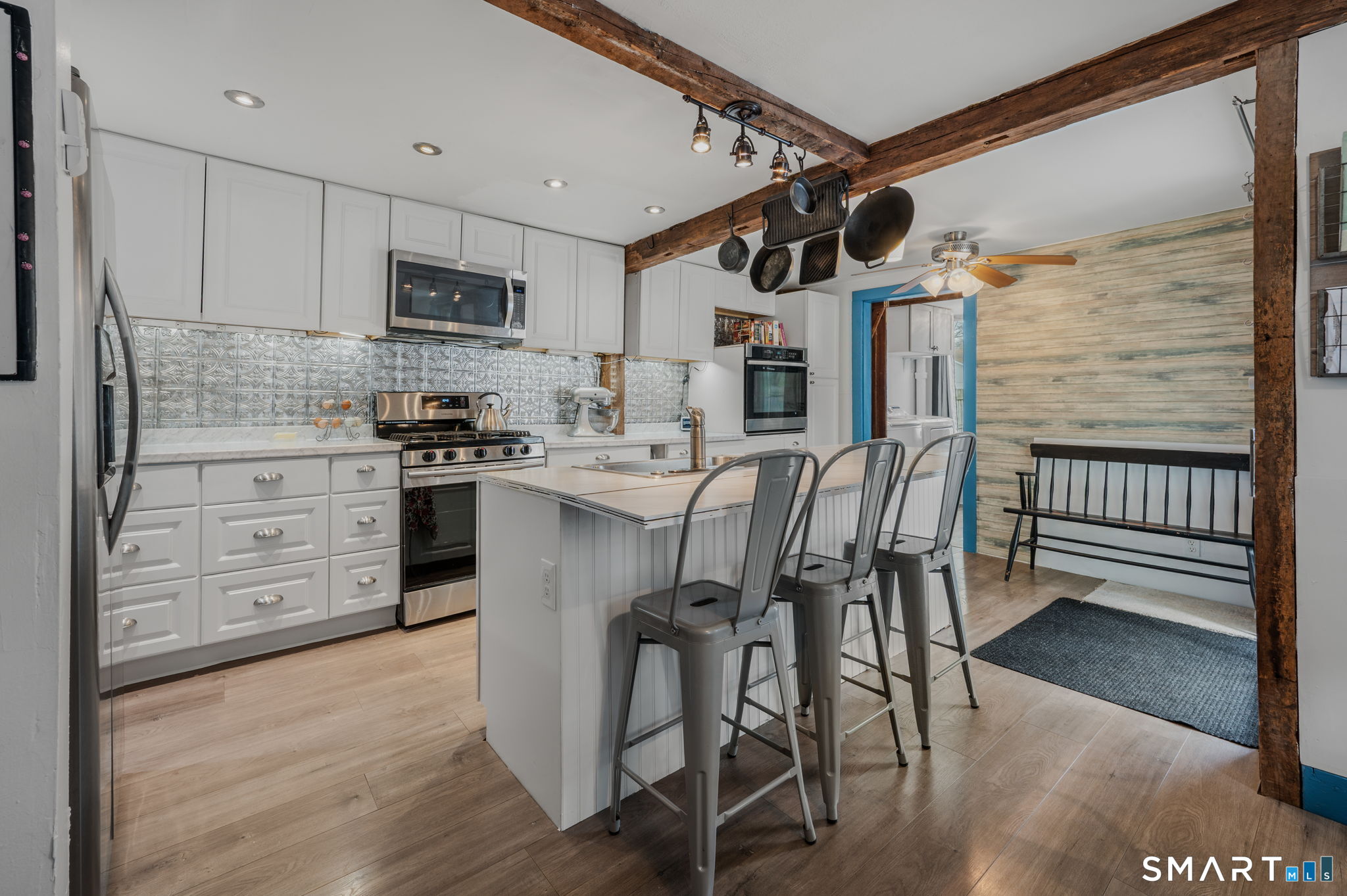 118 Highway 2A Preston, CT 06365 - Photo 10 of 31 a kitchen with stainless steel appliances kitchen island granite countertop a table chairs stove and white cabinets