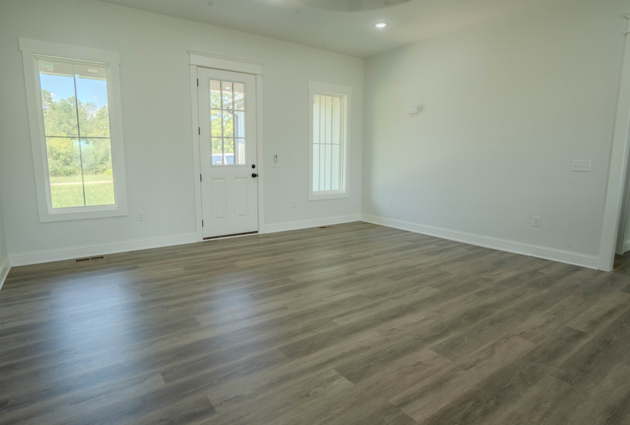 176 Beartown Road Loretto, TN 38469 - Photo 11 of 46 an empty room with wooden floor and windows