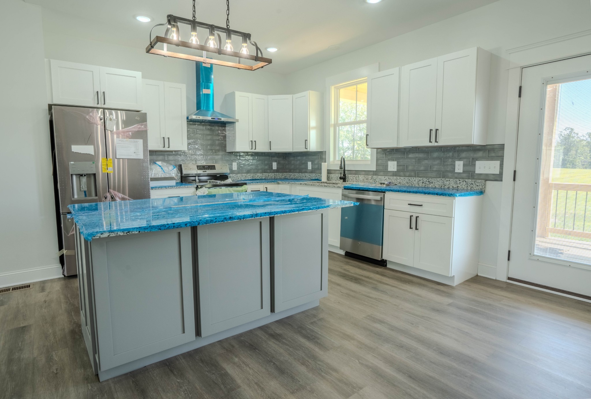 176 Beartown Road Loretto, TN 38469 - Photo 15 of 46 a kitchen with stainless steel appliances granite countertop a sink stove and refrigerator