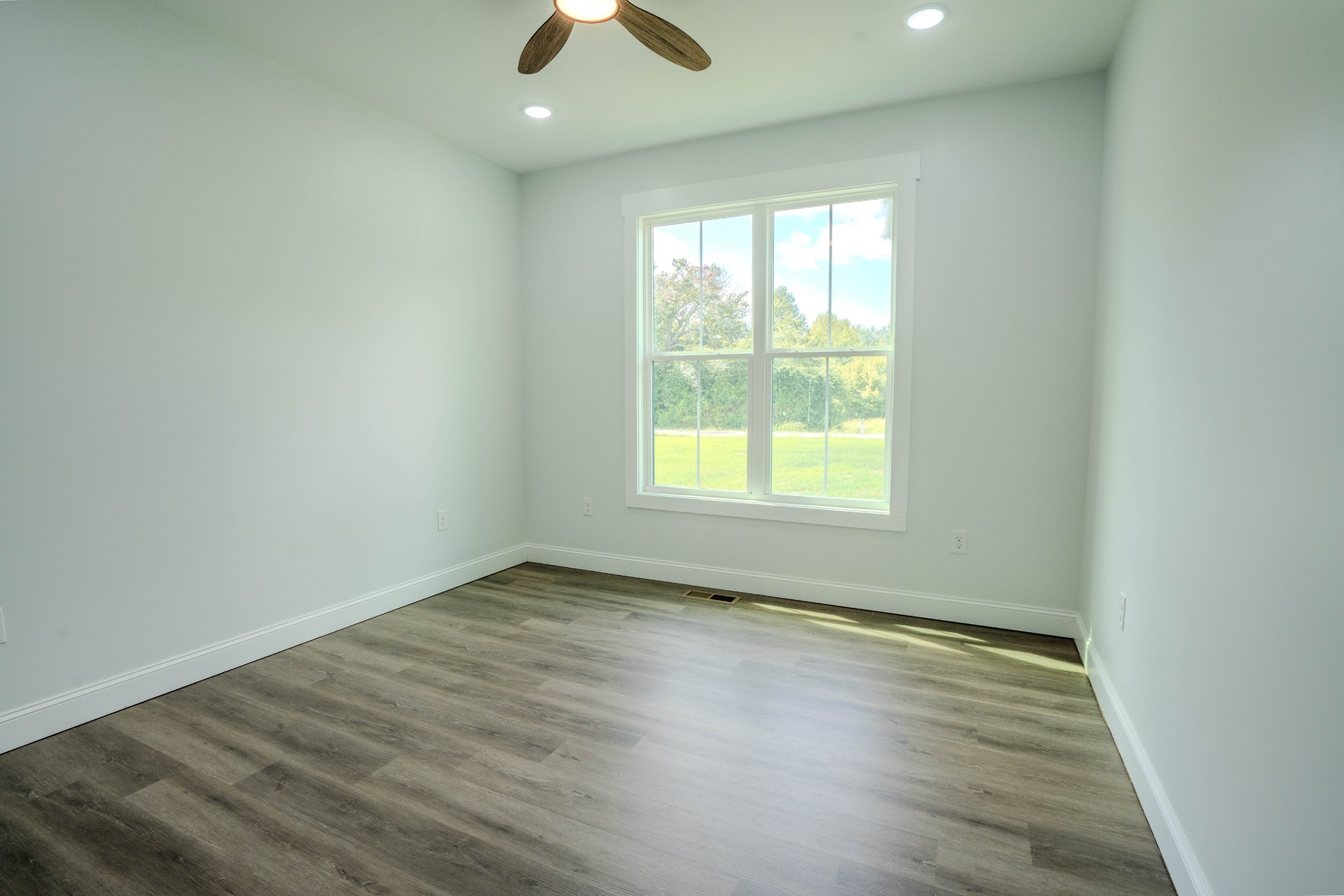176 Beartown Road Loretto, TN 38469 - Photo 23 of 46 an empty room with wooden floor and windows