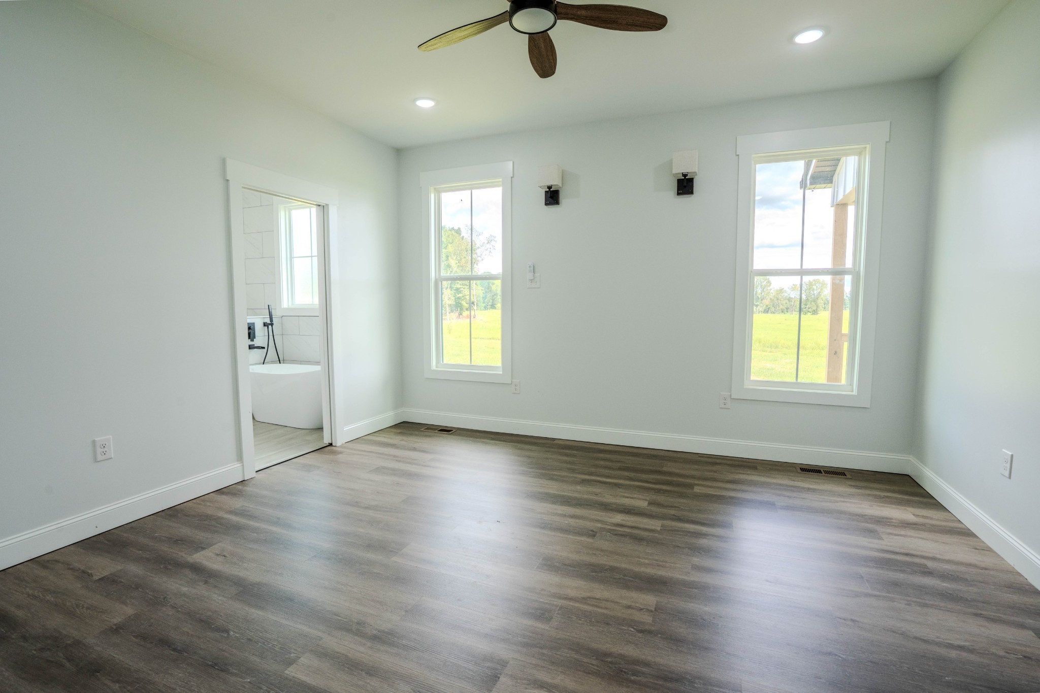 176 Beartown Road Loretto, TN 38469 - Photo 27 of 46 an empty room with wooden floor and windows