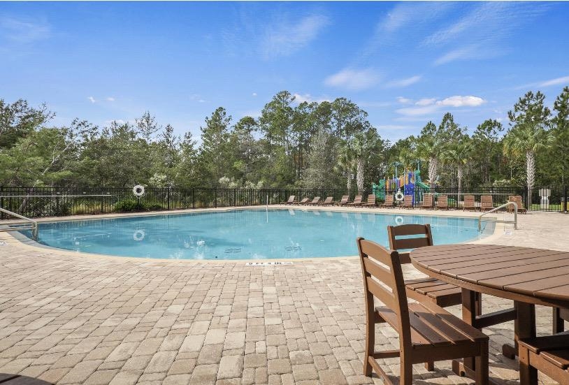 32 Del Mar Circle St. Augustine, FL 32086 - Photo 19 of 21 a view of a wooden dinning table and chairs in the patio