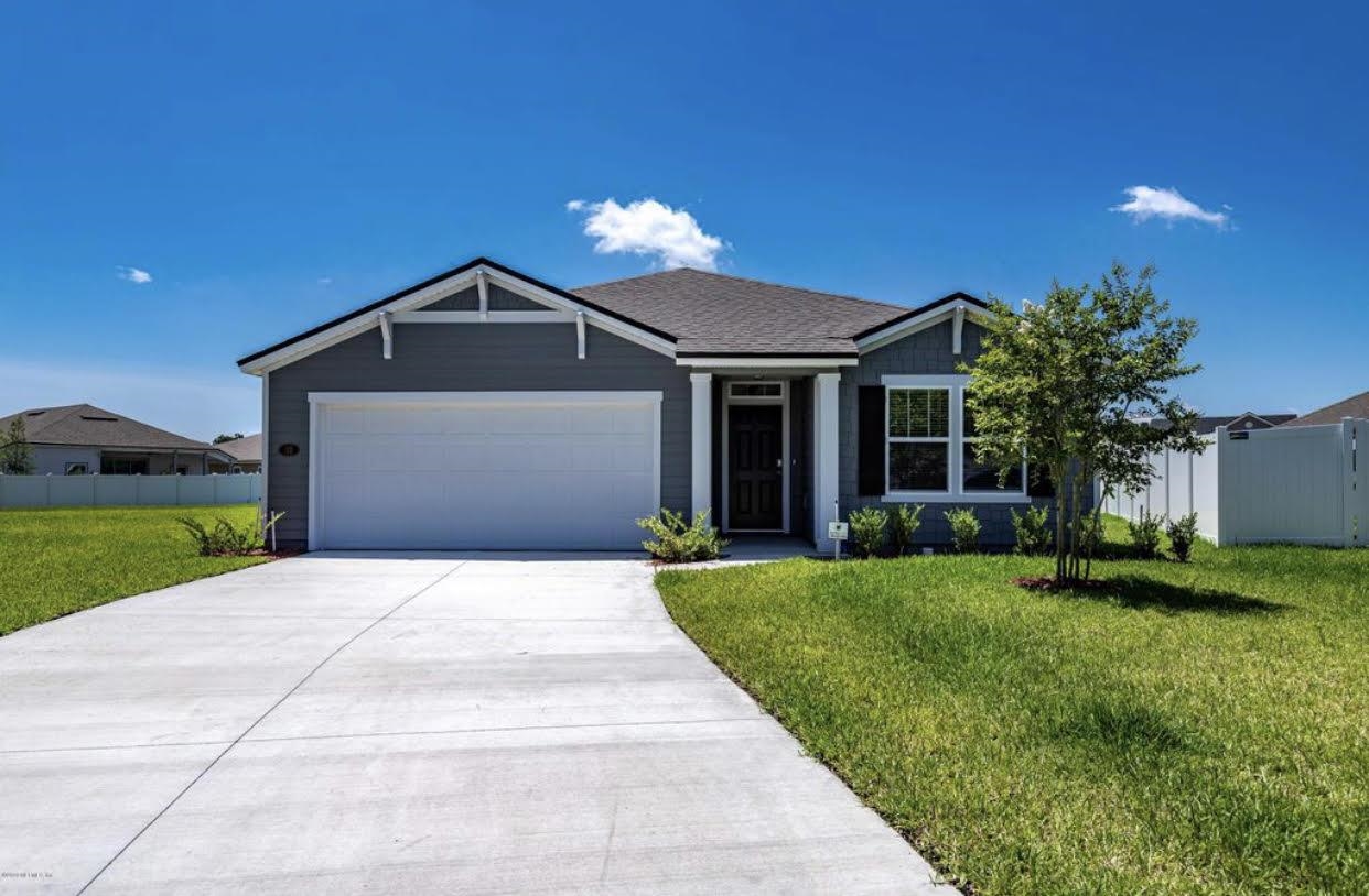 32 Del Mar Circle St. Augustine, FL 32086 - Photo 2 of 21 a front view of a house with a yard and garage