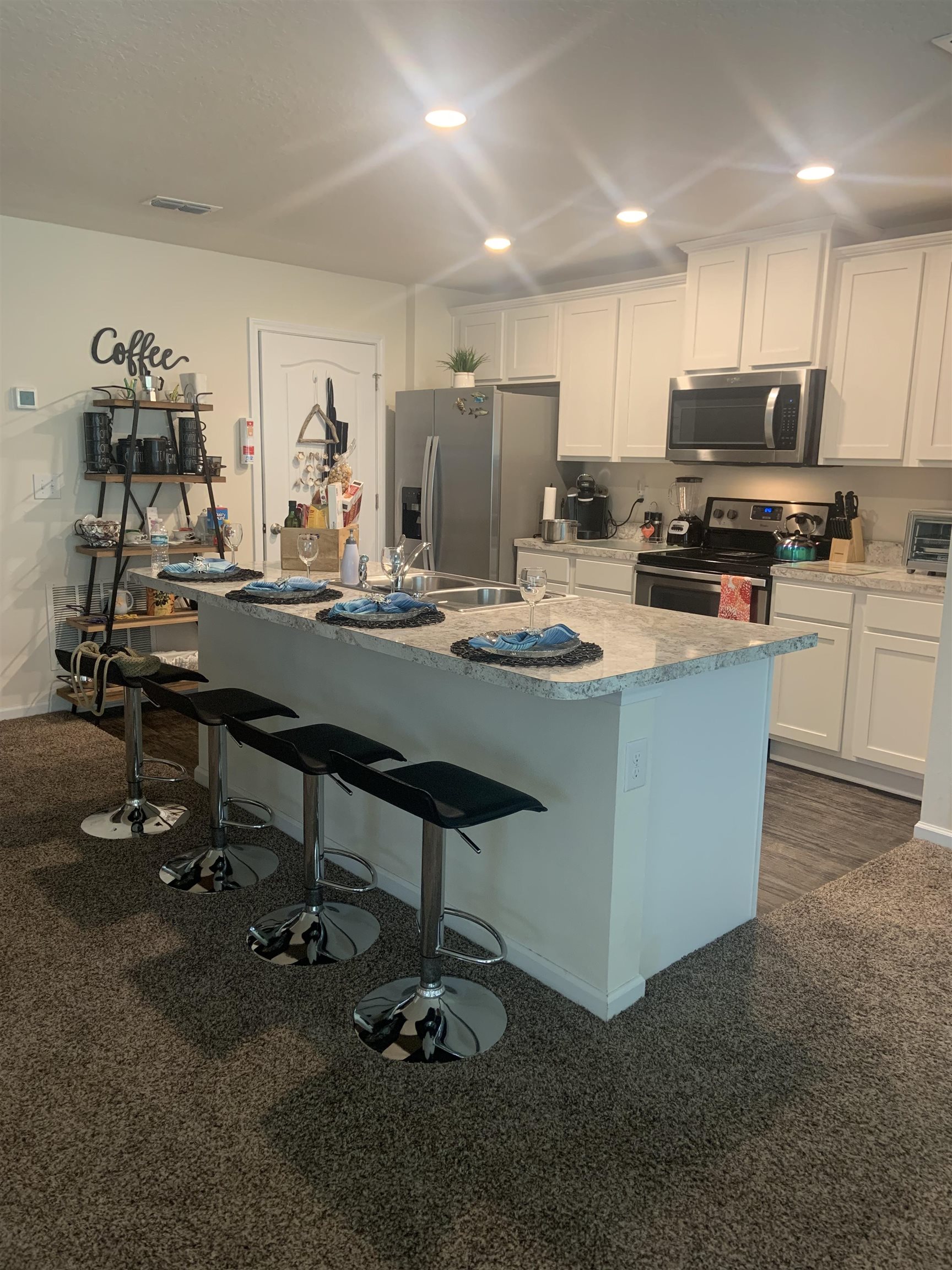 32 Del Mar Circle St. Augustine, FL 32086 - Photo 4 of 21 a kitchen with stainless steel appliances granite countertop a table chairs sink and cabinets