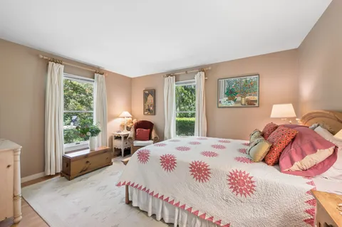 a bedroom with bed and a window