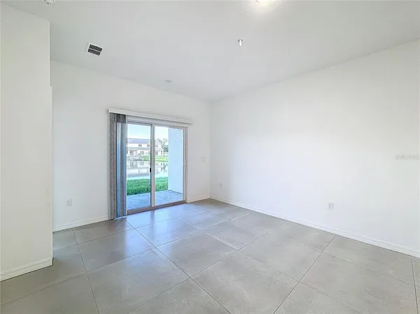 an empty room with a bathroom space and sink