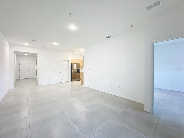 an empty room with closet and windows