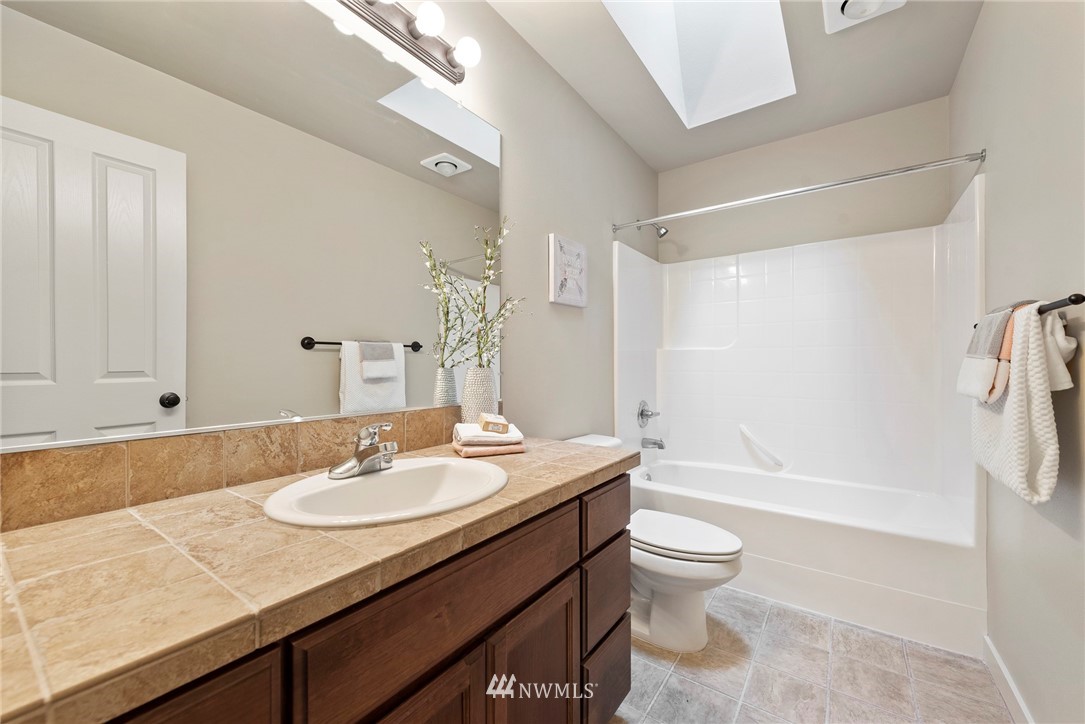 22832 36th Drive Southeast Bothell, WA 98021 - Photo 22 of 26 a bathroom with a granite countertop sink toilet and shower