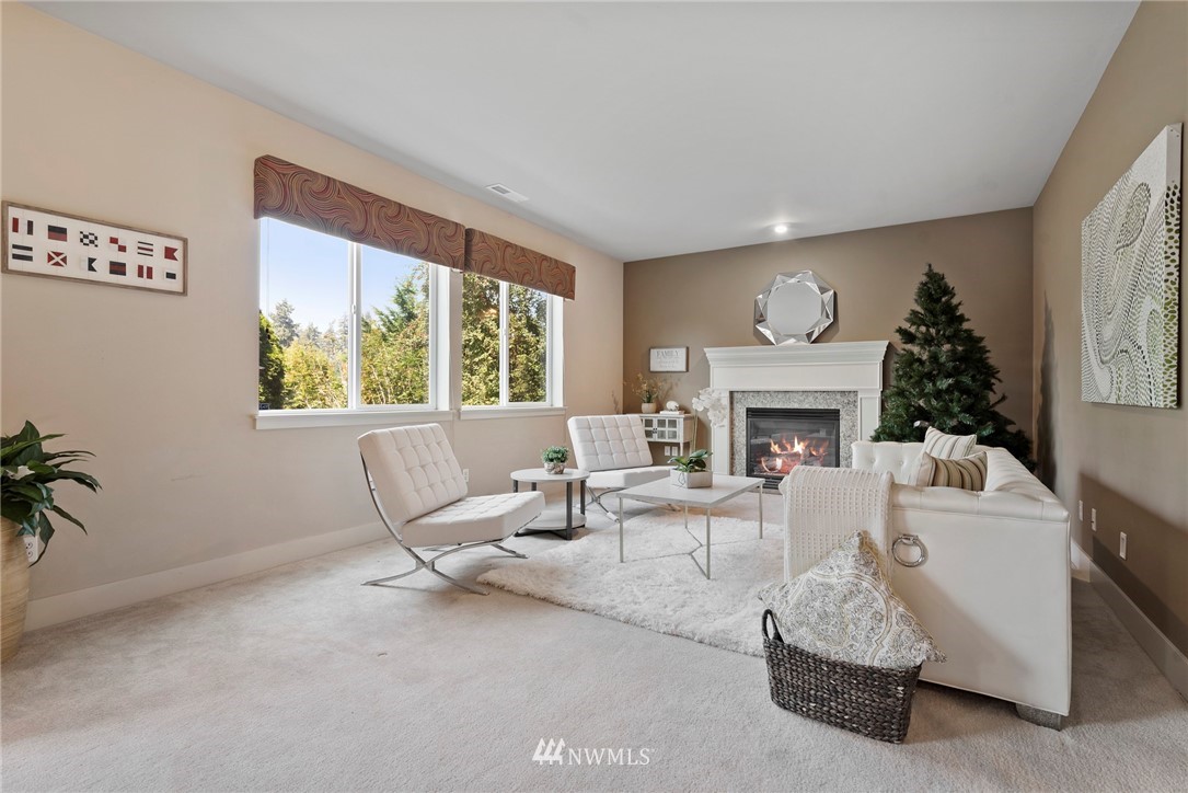 22832 36th Drive Southeast Bothell, WA 98021 - Photo 10 of 26 a living room with furniture a large window and a fireplace