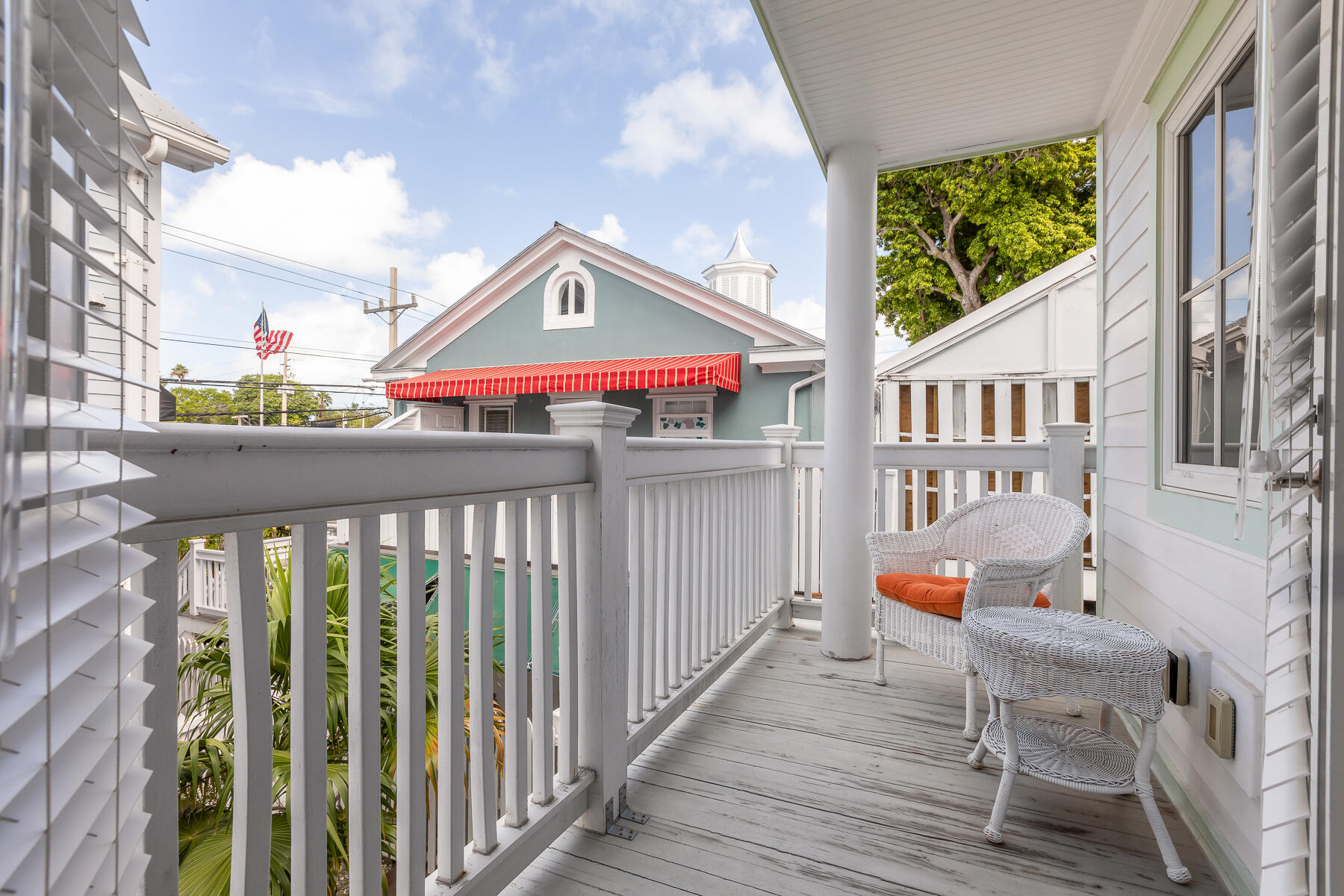 1011 Simonton Street, Unit R1 Key West, FL 33040 - Photo 19 of 35 a view of a patio with table and chairs and wooden floor