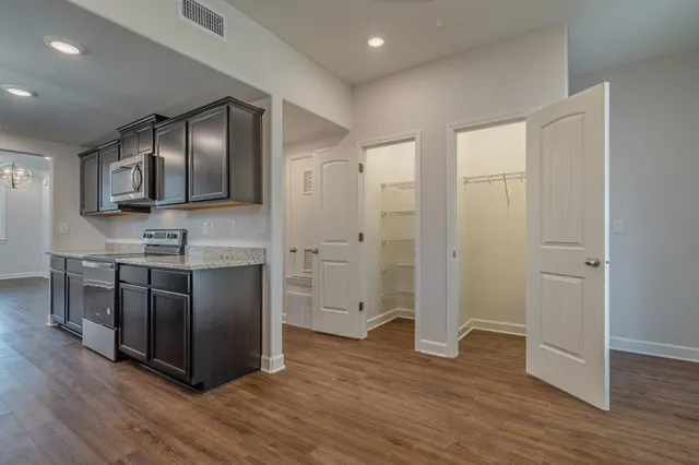 a spacious bathroom with double vanity and a glass door shower