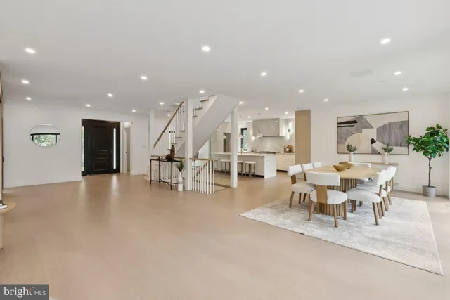 a living room with lots of furniture and a dining table with kitchen view