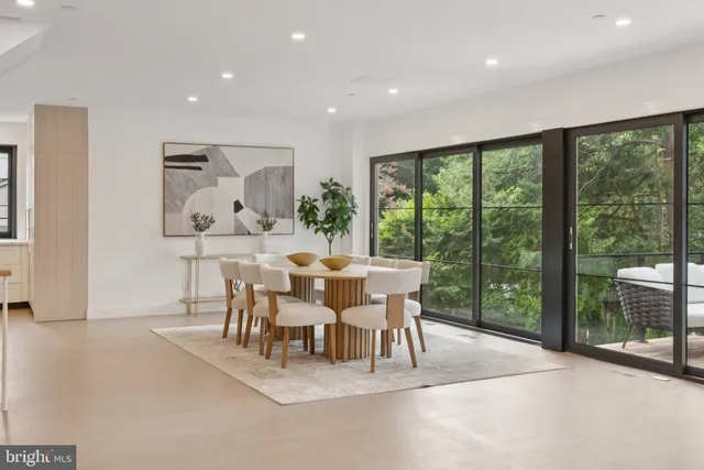 a dining room with furniture and a large window