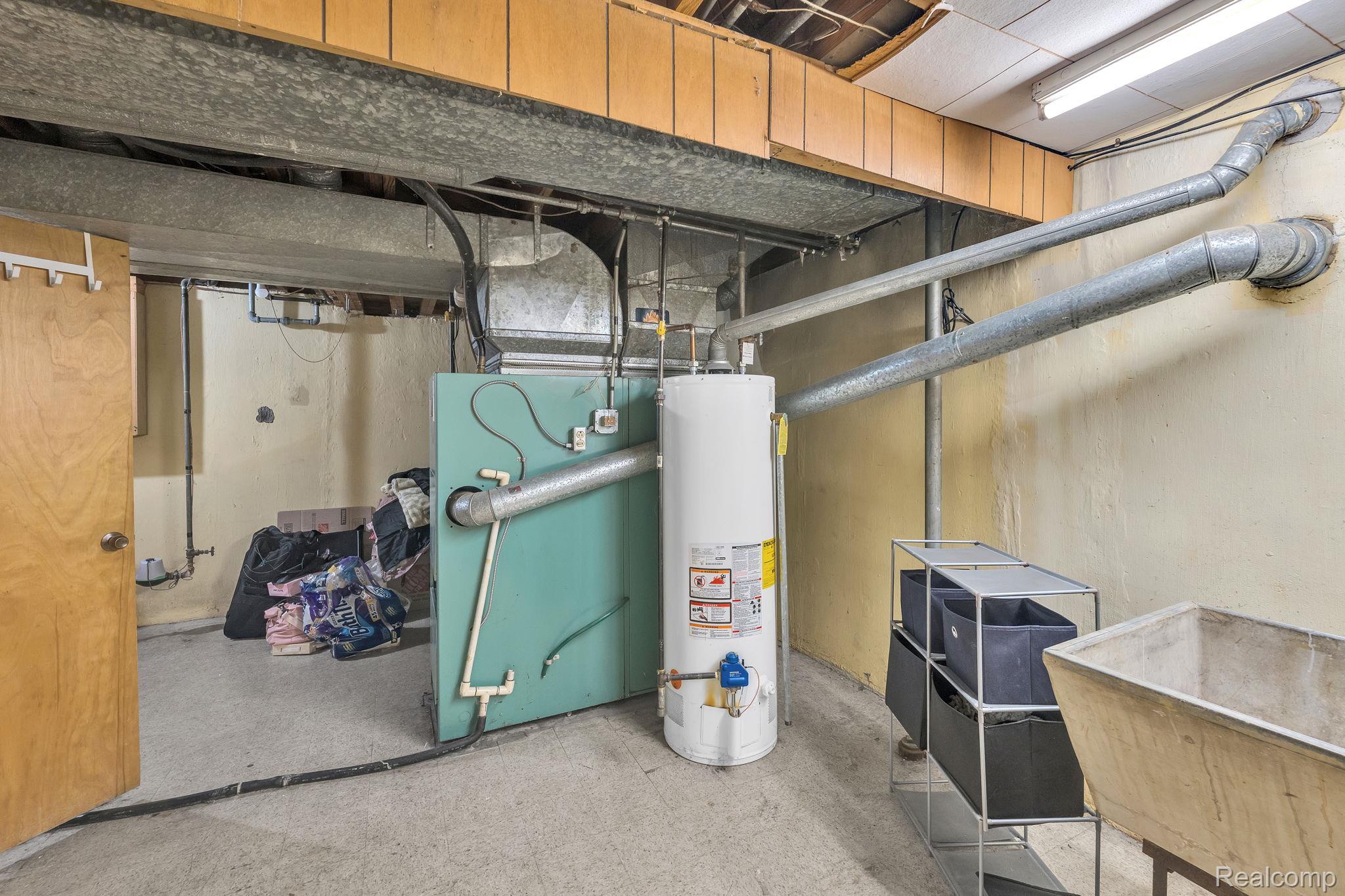 37022 Pinewood Road Wayne, MI 48184 - Photo 21 of 30 Utility room featuring water heater and a sink