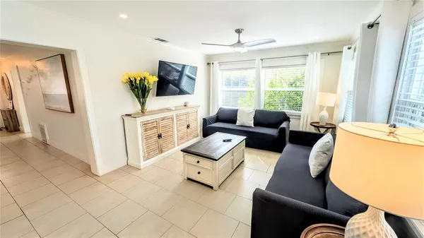 a living room with a fireplace and a large window