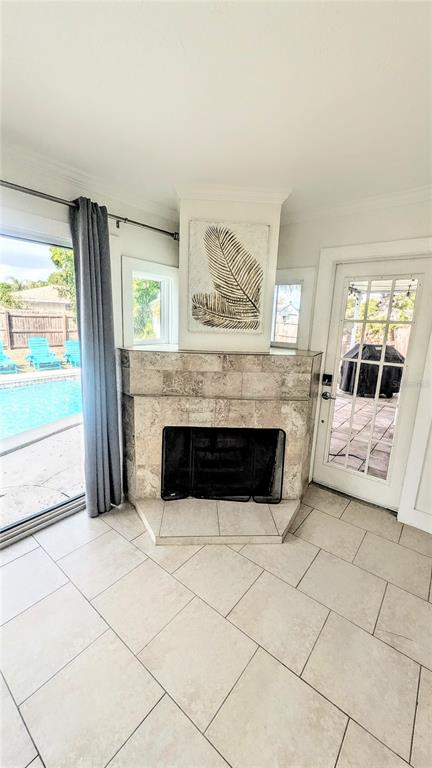 4515 Spahn Street Sarasota, FL 34232 - Photo 13 of 37 a living room with a fireplace and a large window