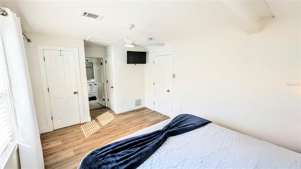 4515 Spahn Street Sarasota, FL 34232 - Photo 17 of 37 a bedroom with a bed and a view of bathroom