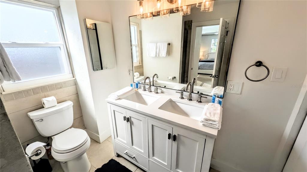 4515 Spahn Street Sarasota, FL 34232 - Photo 18 of 37 a bathroom with a toilet sink and mirror