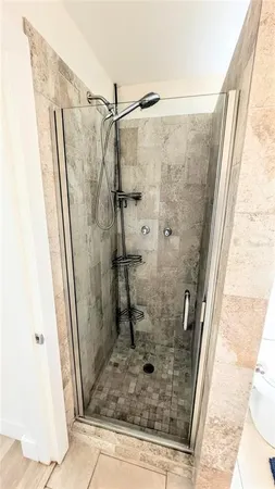 a bathroom with a shower and a sink