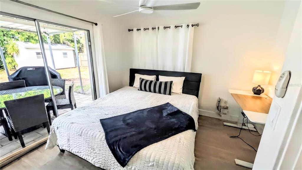 4515 Spahn Street Sarasota, FL 34232 - Photo 22 of 37 a bedroom with a bed a chair and next to a window